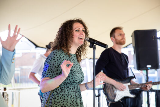 a woman sings into a microphone