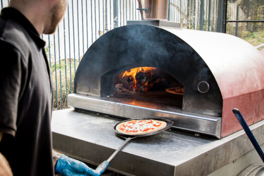 pizza is removed from an oven
