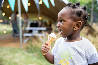 young girl eats an ice cream