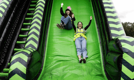 Simple Fest Staff going down the slide